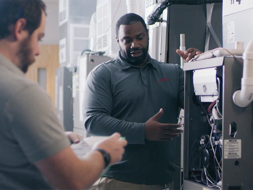 Men looking at a new furnace installation